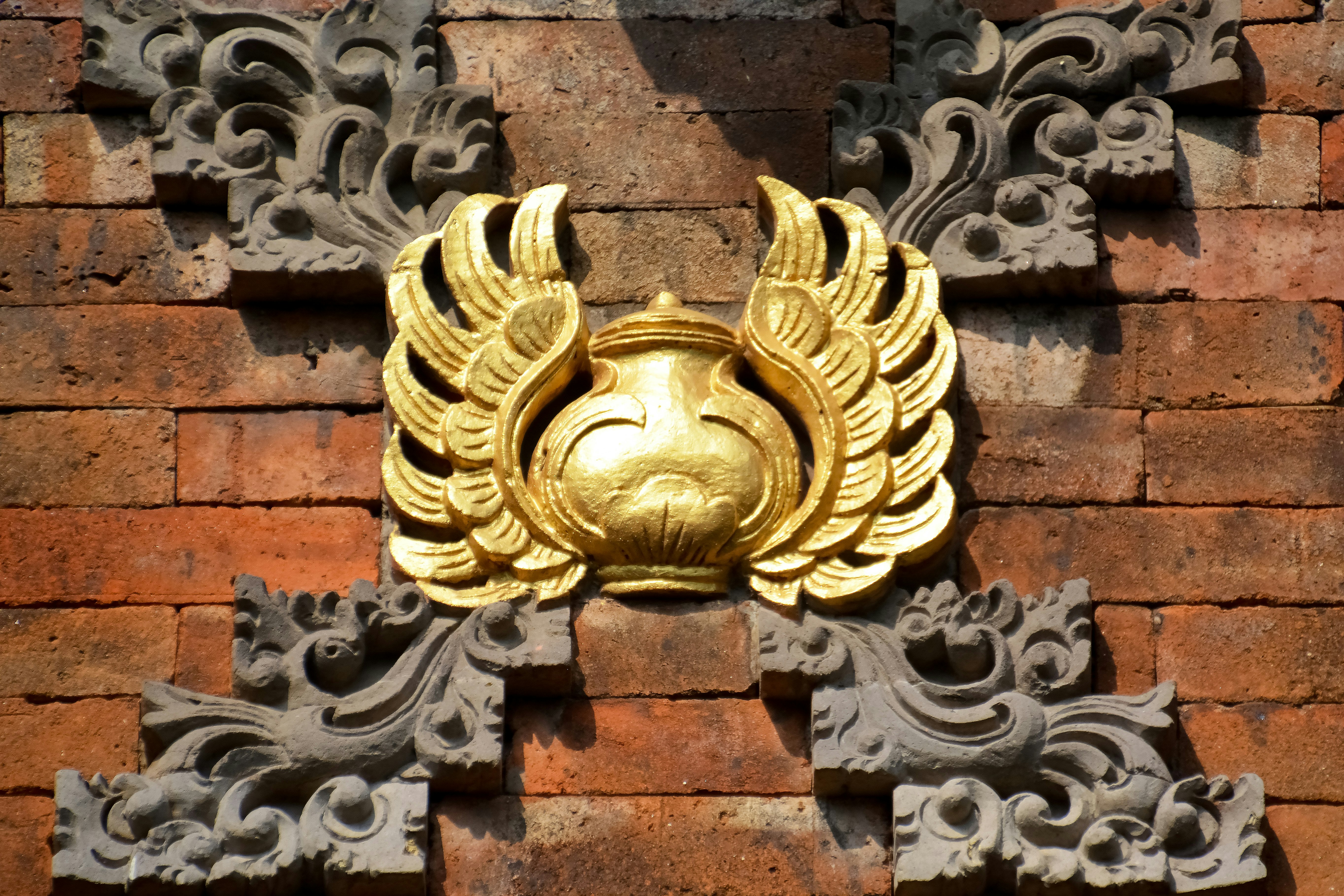 gold door knob on brown brick wall